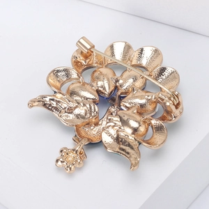 Elegant gold peacock brooch featuring a luxury floral back structure with safety pin clasp