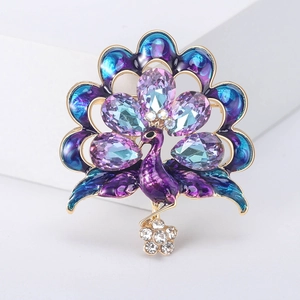Elegant gold peacock brooch with purple and blue enamel and faceted crystals for coats