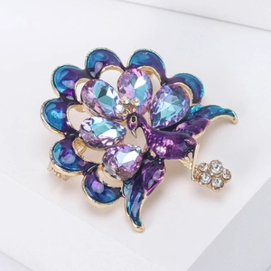 Detailed view of elegant blue peacock brooch with purple crystals and enamel work