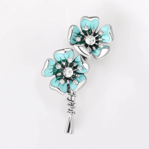 Close-up of blue enamel flower brooch with sparkling crystals and silver finish
