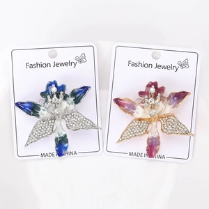 Detailed close-up of orchid brooches with rhinestones and enamel on display cards