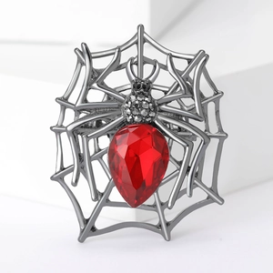 Gothic spider web brooch with a large red pear-shaped gemstone and gunmetal finish