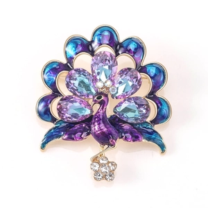 Macro detail of elegant peacock brooch with purple crystals and blue enamel finish