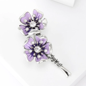 Detail view of purple floral brooch with crystal rhinestones and vintage silver finish