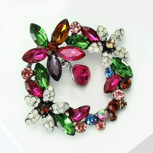 Macro detail of colorful crystal wreath brooch with multi-shape marquise gemstones