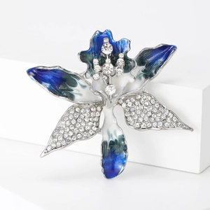 Detail of flower brooch with blue enamel petals and sparkling white rhinestones