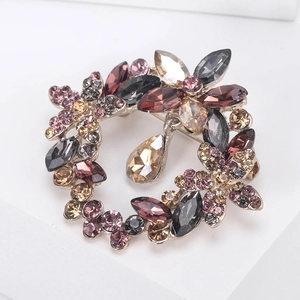 Macro detail of floral crystal brooch with silver alloy base and teardrop pendant