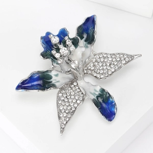Detail of silver flower brooch with blue enamel petals and sparkling rhinestones