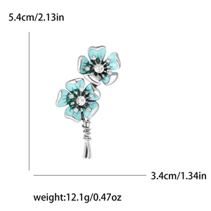 Elegant floral brooch with teal enamel petals and crystals, 5.4cm height, silver base