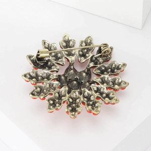 Baroque style floral brooch back view with bronze alloy texture and red beads