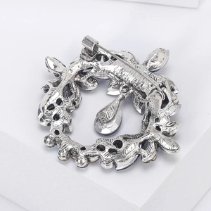Detail view of the intricate silver alloy back and clasp of the crystal wreath brooch