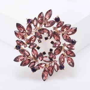 Macro detail of purple crystal circular brooch with elegant gold claw settings
