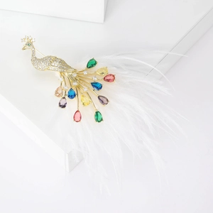 Vintage gold peacock brooch with colorful crystals and elegant white feathers