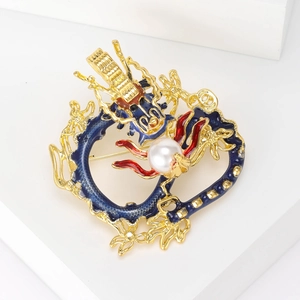 Detailed macro view of a dragon brooch with blue enamel and a white pearl accent