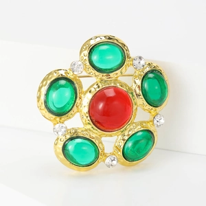 Vintage style palace brooch with red and green glass gems on a gold flower metal frame