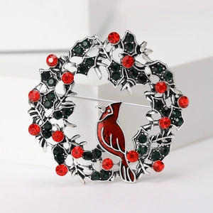 Christmas wreath brooch featuring a cardinal bird with red and green rhinestones