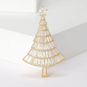 Nahaufnahme einer vergoldeten Weihnachtsbaum-Brosche mit funkelnden Baguette-Kristallen