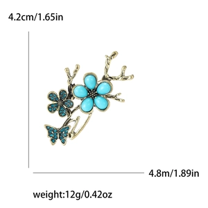 Elegant gold butterfly and branch brooch with blue gems for suits and coats
