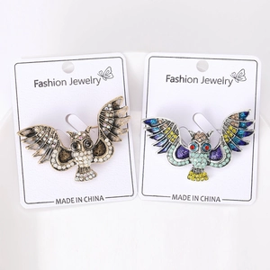 Detailed close-up of alloy owl brooches with rhinestones and colorful oil drip craft