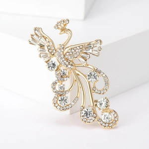Macro detail of luxury gold-tone peacock brooch with sparkling white zircons and crystals