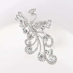 Macro detail of silver alloy phoenix brooch with shimmering crystal rhinestones