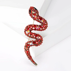 Elegant S-shaped snake brooch inlaid with red rhinestones and crystal accents on bronze base