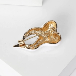 Creative crown tooth brooch in gold-tone alloy with white enamel and hammer texture detail