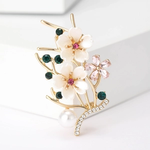 Detail of floral peach branch brooch with white flowers, pink crystals and a pearl