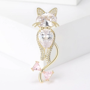 Macro shot of cat brooch with oval and pear zircons on gold metal base