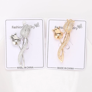 Detailed comparison of gold and silver tulip brooches with micro-set zircon accents