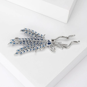 Fashionable wheat ear brooch with blue zircon inlay on white minimalist geometric block