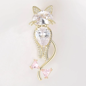 Detail of cute cat brooch with oval cubic zirconia and pink crystal bow accent
