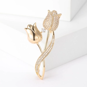 Detailed macro view of a golden tulip brooch with sparkling pavé zircons and polished petals