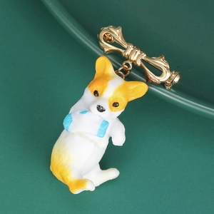 Detailed close-up of a cartoon Corgi dog brooch with a golden bow tie pin accessory