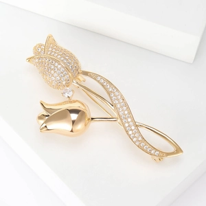 Close-up of elegant tulip brooch with micro-paved cubic zirconia and polished gold finish