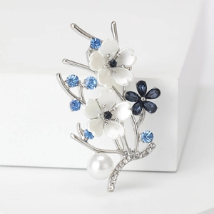 Elegant floral peach blossom brooch with blue gems, pearls, and silver-tone finish