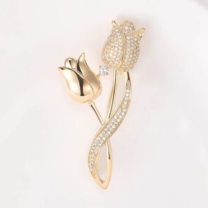 Macro detail of tulip brooch featuring micro-set cubic zirconia and golden polished finish
