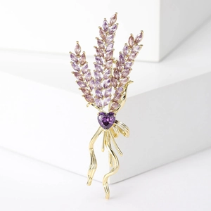 Macro detail of a wheat ear brooch with purple marquise zircons and a heart gem