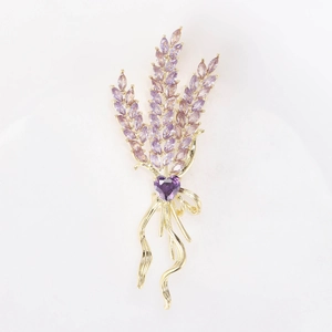 Close-up of lavender brooch with purple stones and gold bow tassel detail
