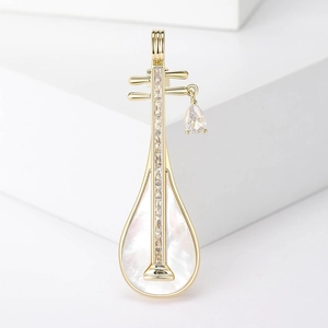 Detailed view of pipa brooch with mother of pearl inlay and teardrop gemstone pendant