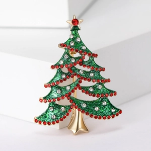 Macro detail of Christmas tree brooch with green enamel and sparkling rhinestones