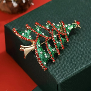 Elegant gold-tone hollow Christmas tree brooch with green enamel and sparkling red rhinestones