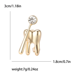 Spilla creativa a forma di dente e specchio dentale placcata oro con zircone cubico