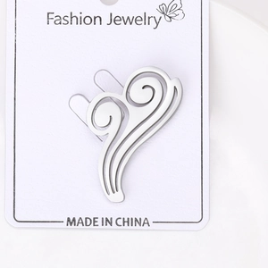 Macro shot of a silver cloud-shaped brooch on a Fashion Jewelry display card