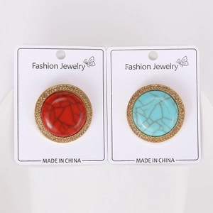 Detail of vintage Tibetan style brooches with red and blue crackle texture and crystals