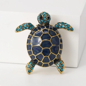 Detail of vintage turtle brooch with blue enamel shell and sparkling light blue rhinestones