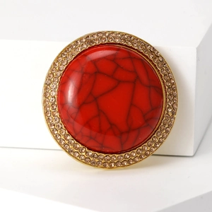 Vintage Tibetan-style round brooch with red cracked resin stone and gold rhinestone trim