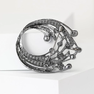 Detailed back view of silver brooch showing secure pin fastener and metal texture