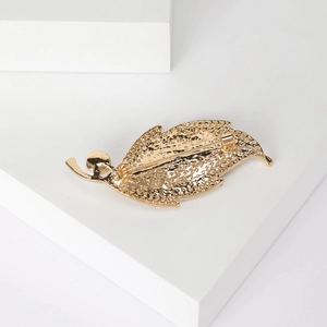 Back view of elegant gold leaf brooch with textured finish and secure pin safety clasp