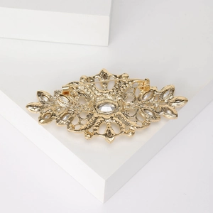 Vintage gold crystal brooch with hollow pattern and safety pin back view